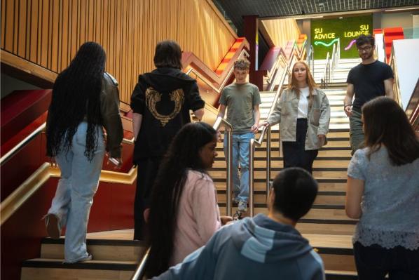 students walking down staircase in One Elmwood